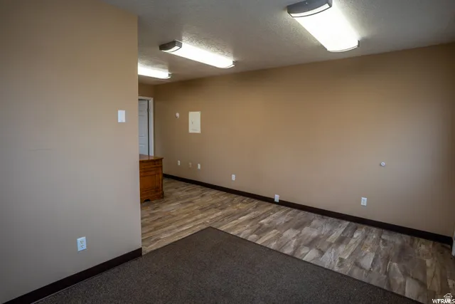 Wood-finish flooring, recessed lighting, and neutral wall tones