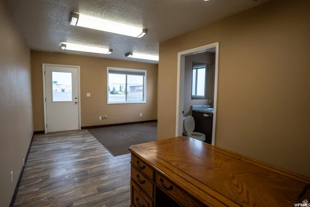 Wood-finish flooring, recessed lighting, and a window with exterior views