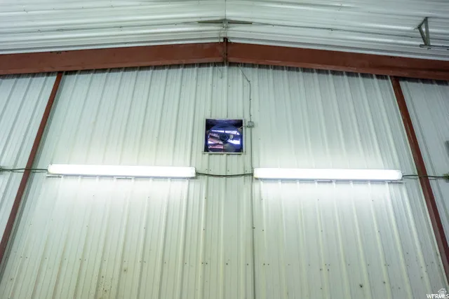 Corrugated metal interior walls, exposed structural beams, fluorescent lighting, and an integrated ventilation fan