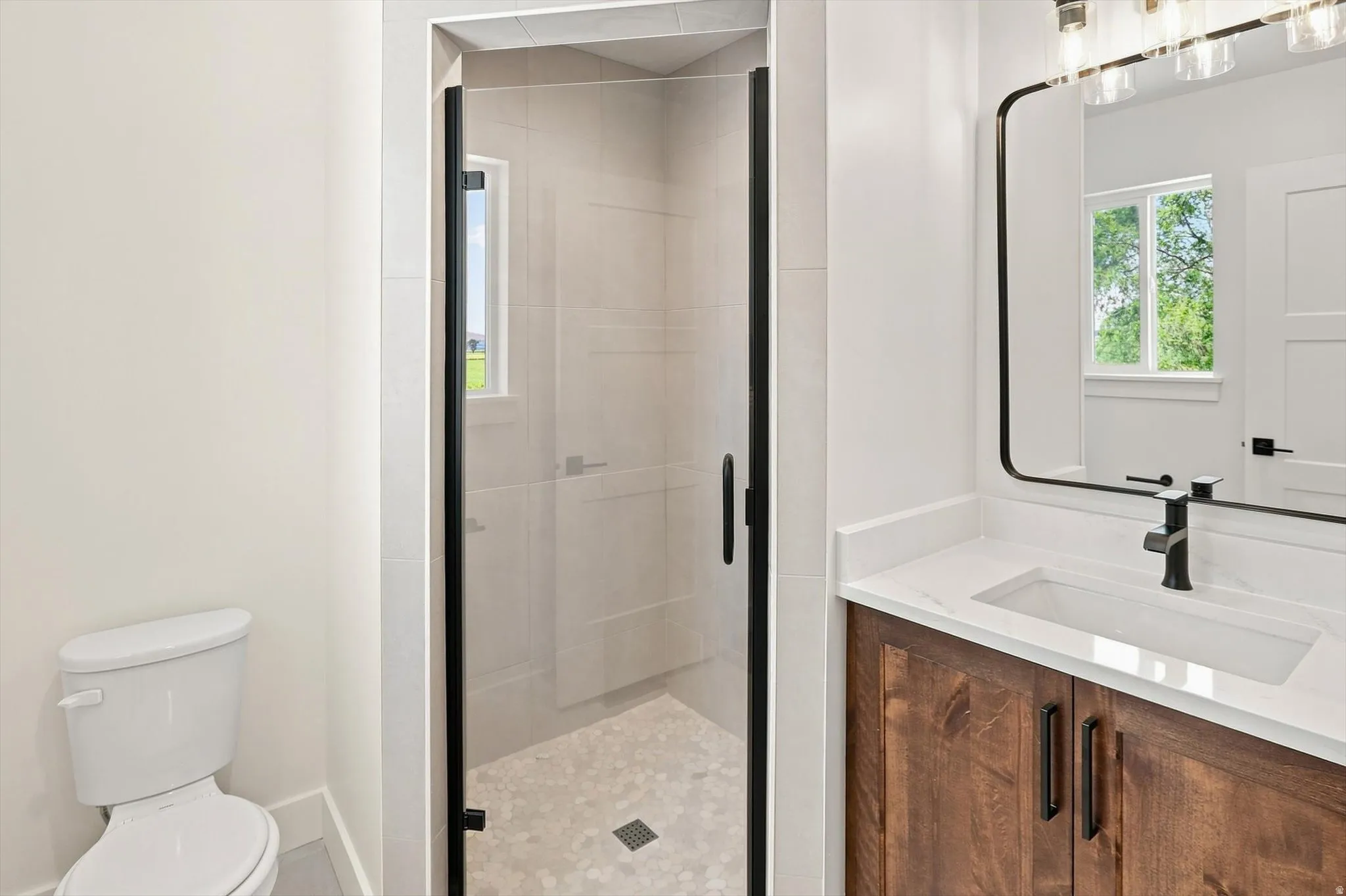 Custom wood-finish vanity with a white countertop and integrated sink