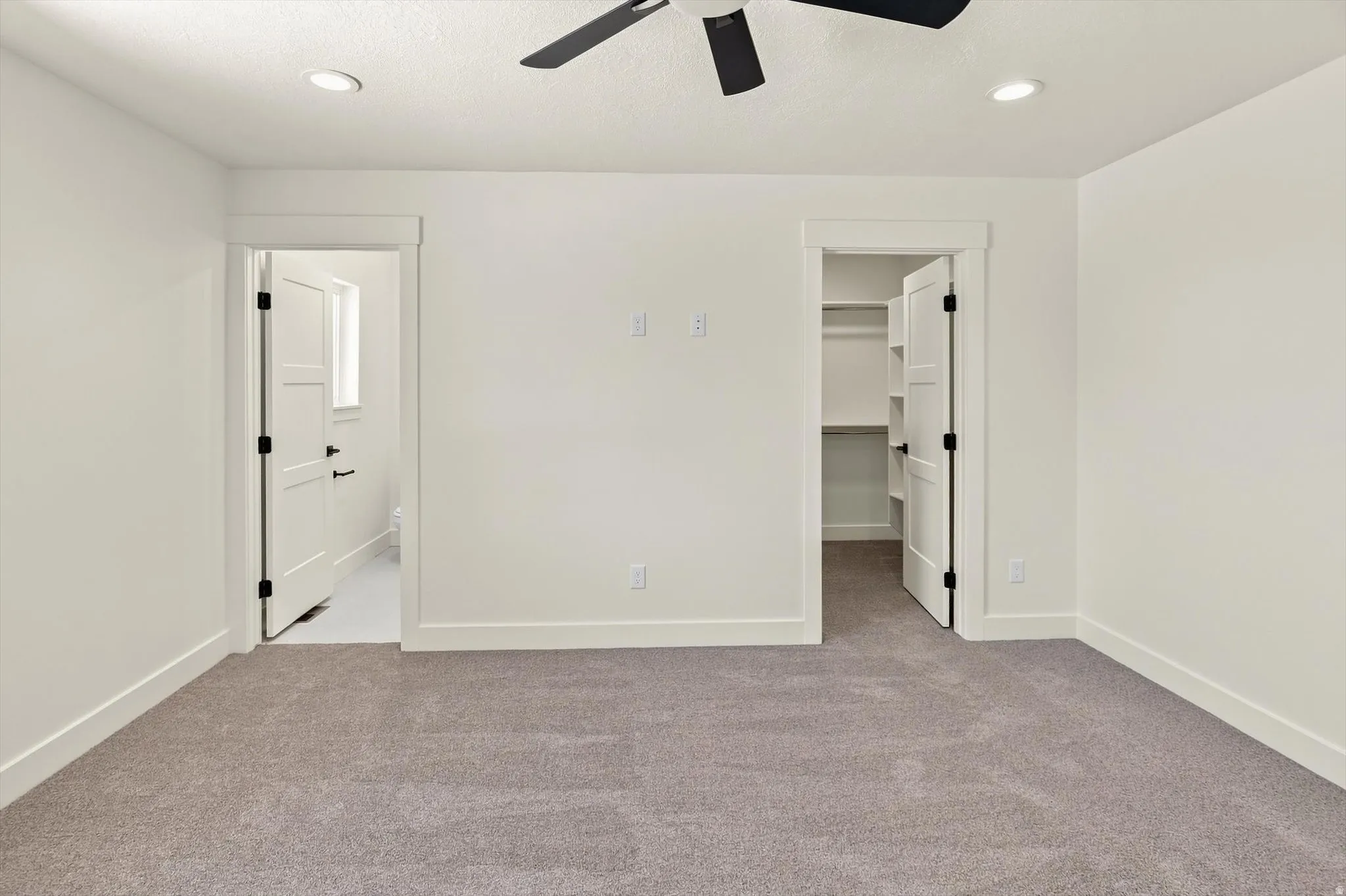 Plush carpet flooring, recessed lighting, ceiling fan, and built-in closet shelving