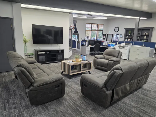 Expansive interior space featuring carpet flooring, built-in shelving, and large windows