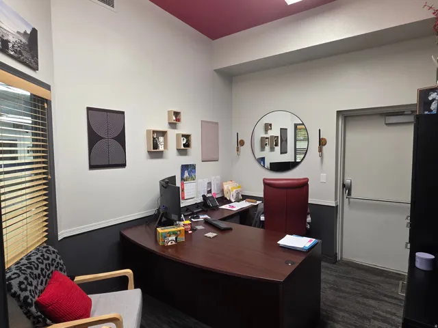 Professional workspace featuring a wood-finish desk and high ceilings