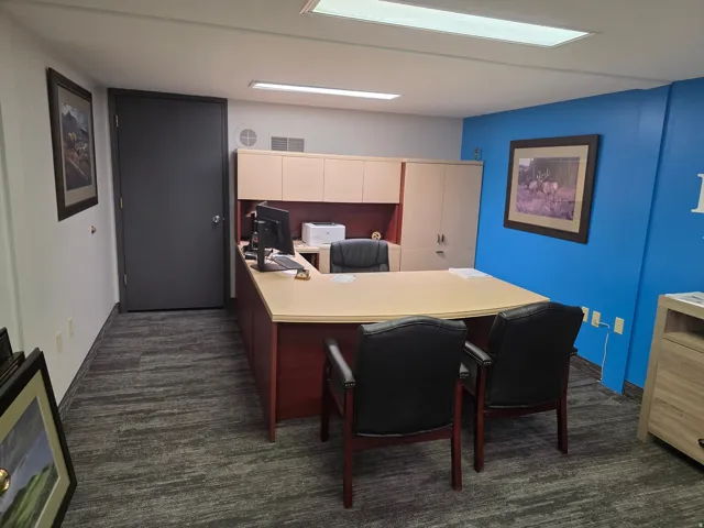 Commercial space featuring carpeted flooring, built-in cabinetry, and overhead lighting