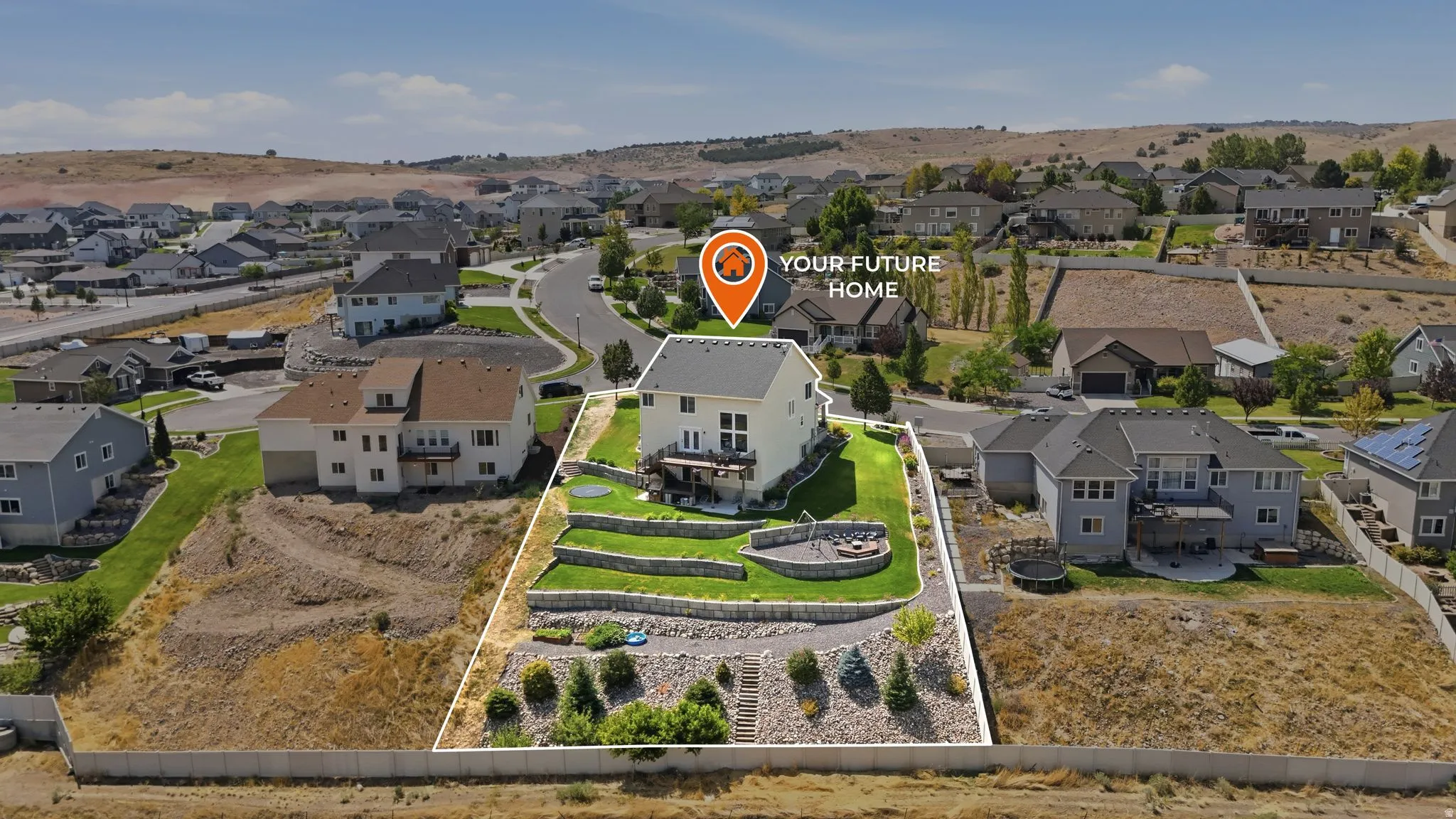 Two-story residence with a multi-level backyard, featuring terraced landscaping and retaining walls