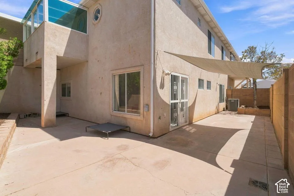 Expansive concrete patio with partial shade coverage