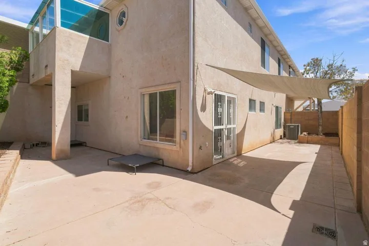 Expansive concrete patio with partial shade coverage