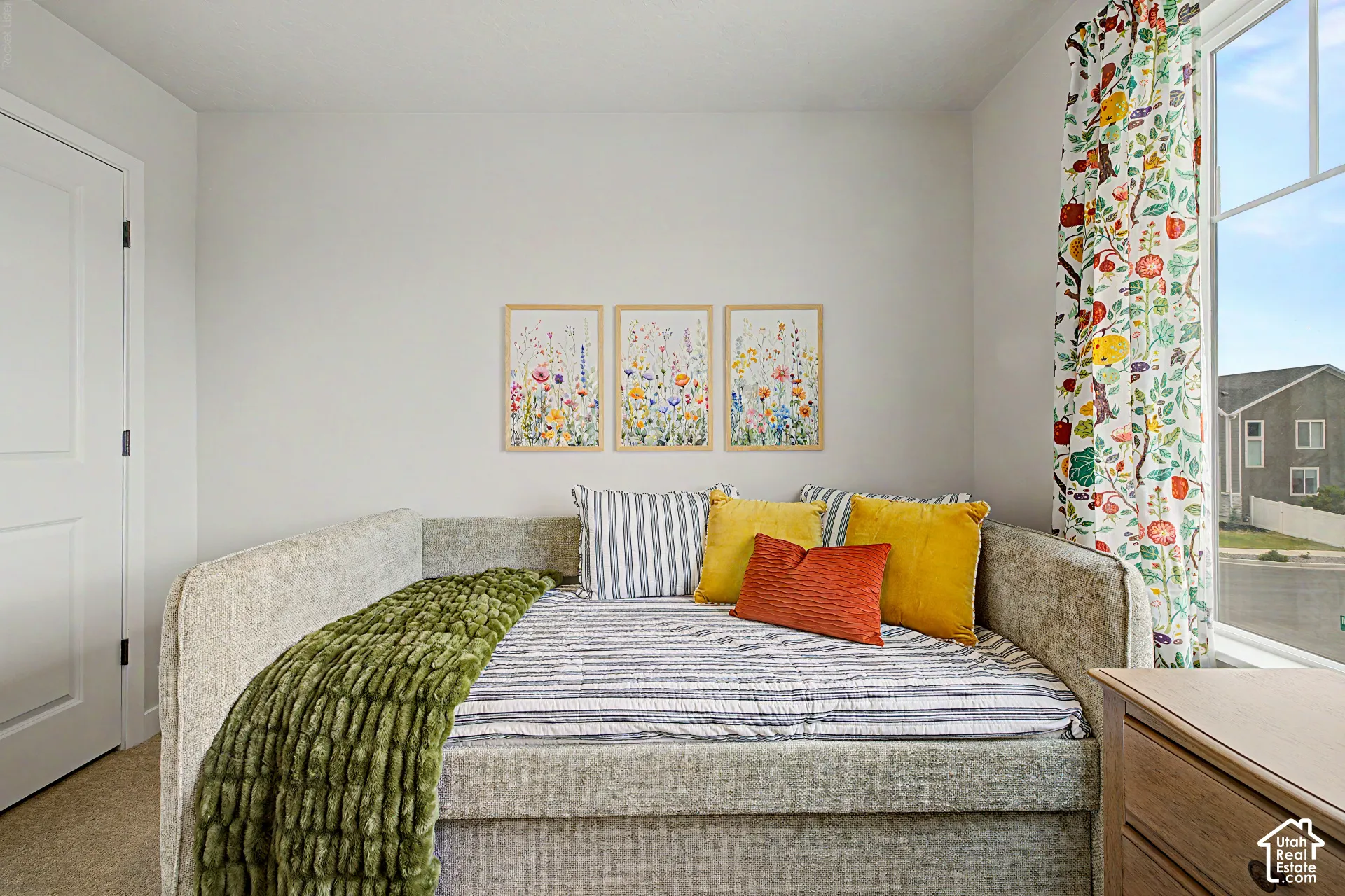Light-colored walls with a window featuring a white frame