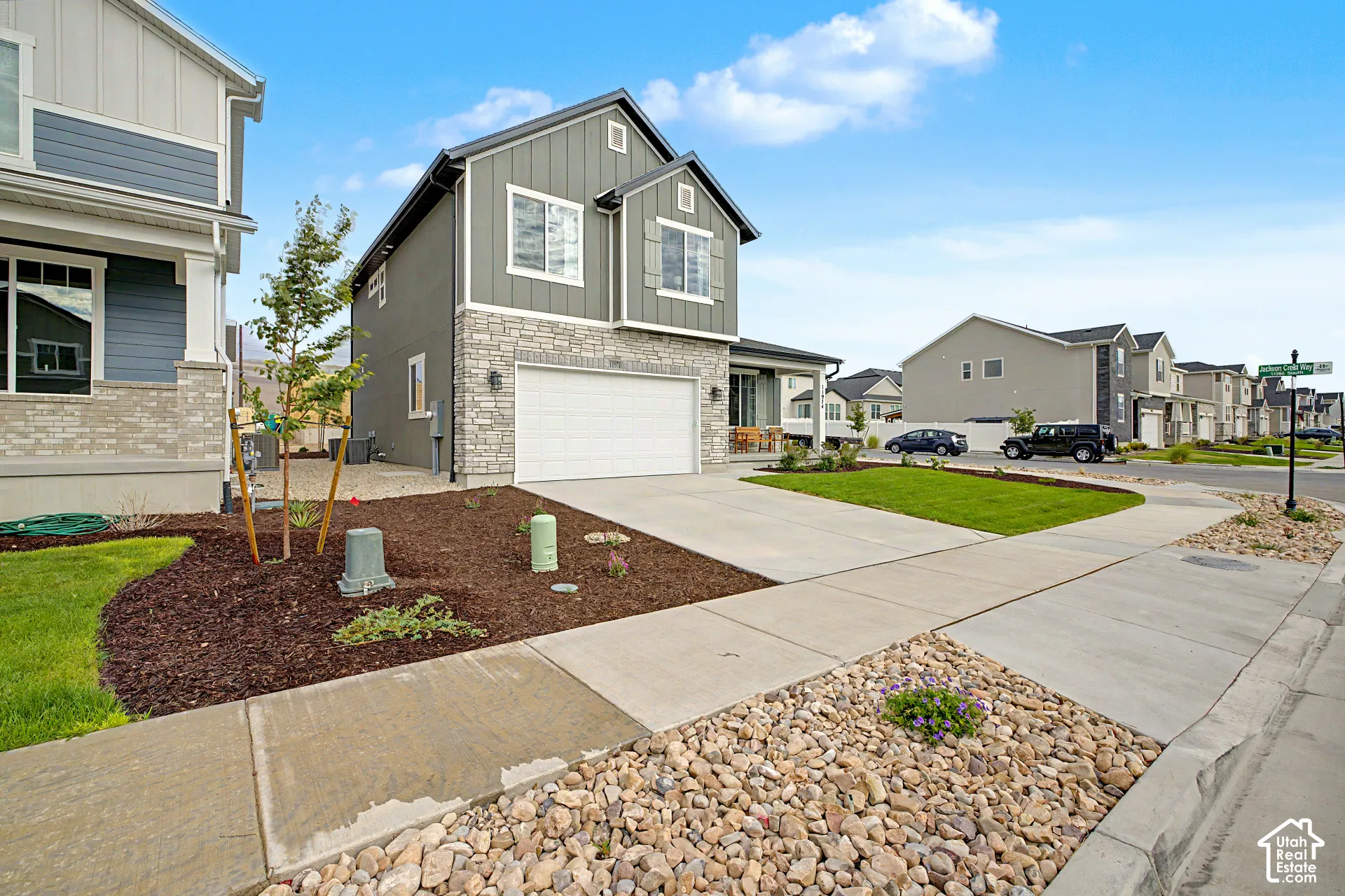 Two-story exterior with vertical siding and stone accents