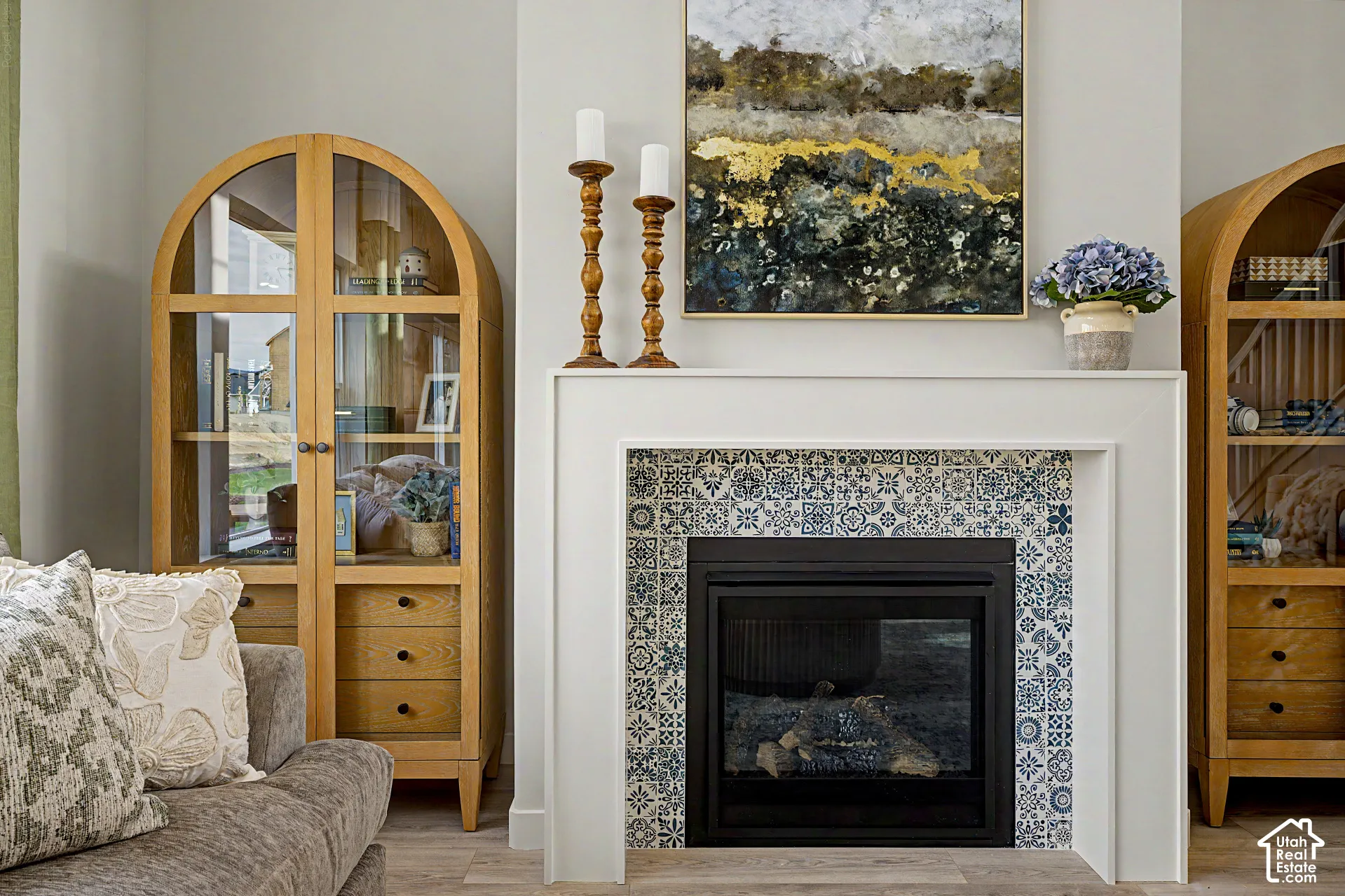 Fireplace with decorative tile surround and white mantel