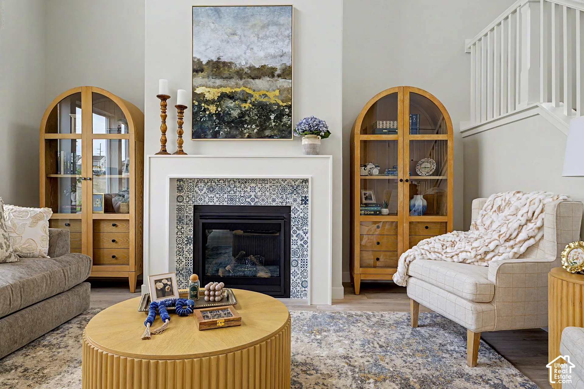 Fireplace with decorative tile surround and white mantel