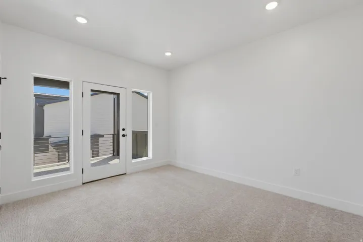 Recessed lighting illuminates a neutral color palette