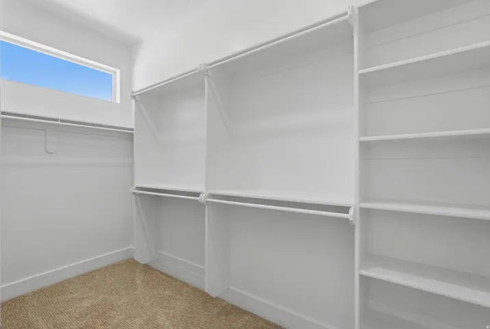 Built-in closet system featuring multiple hanging rods and shelving units