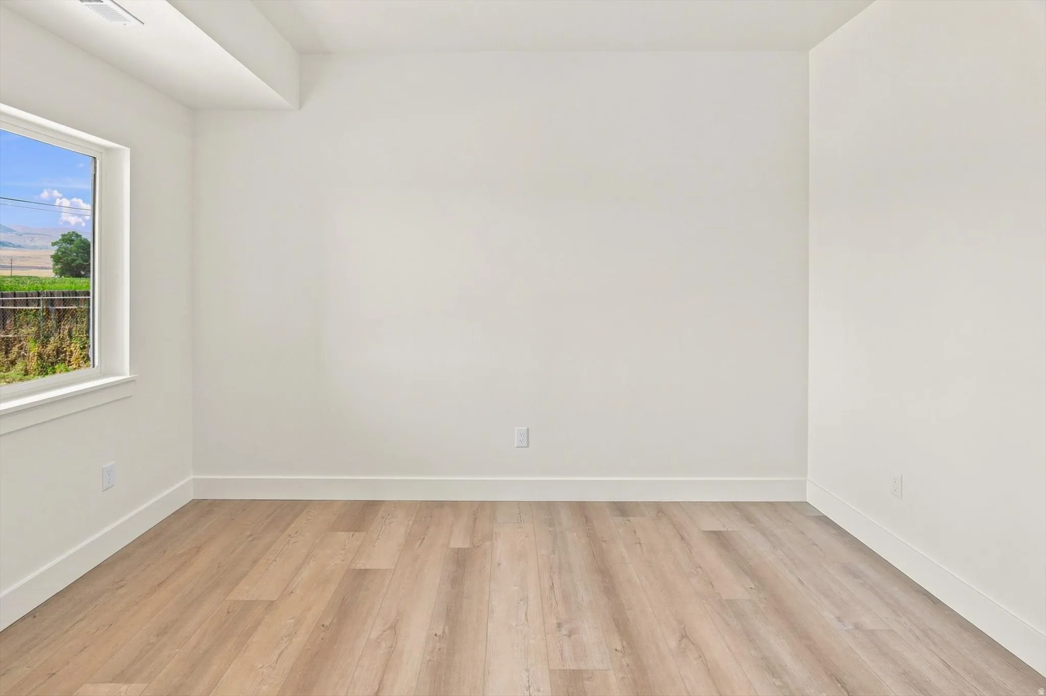 Neutral white walls with wood-finish flooring