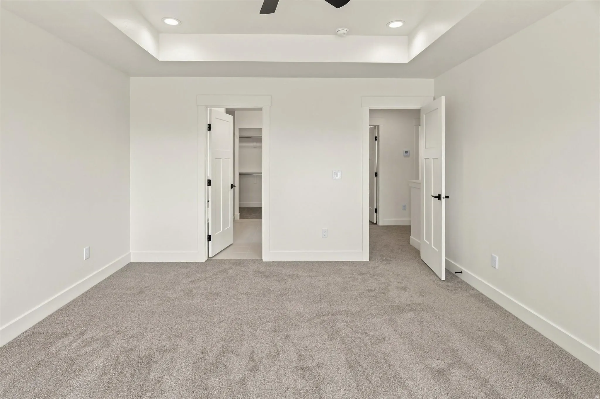 Tray ceiling with recessed lighting and a ceiling fan