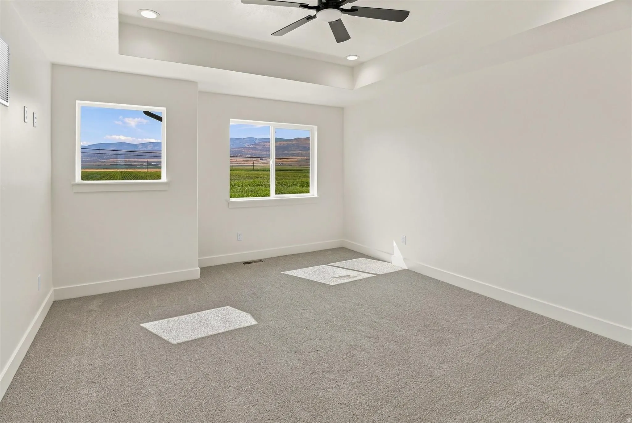 Recessed lighting, ceiling fan, coffered ceiling, and carpet flooring
