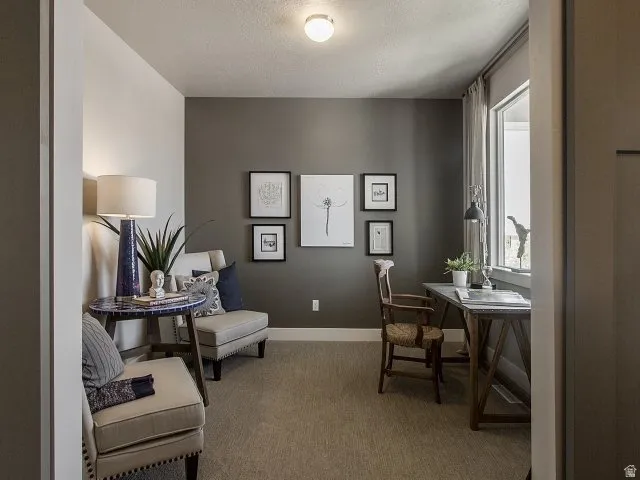 Carpeted room with a feature wall, window with drapes, and recessed lighting. *Not actual home. Buyer will choose their own cabinets, counters, and fixtures.