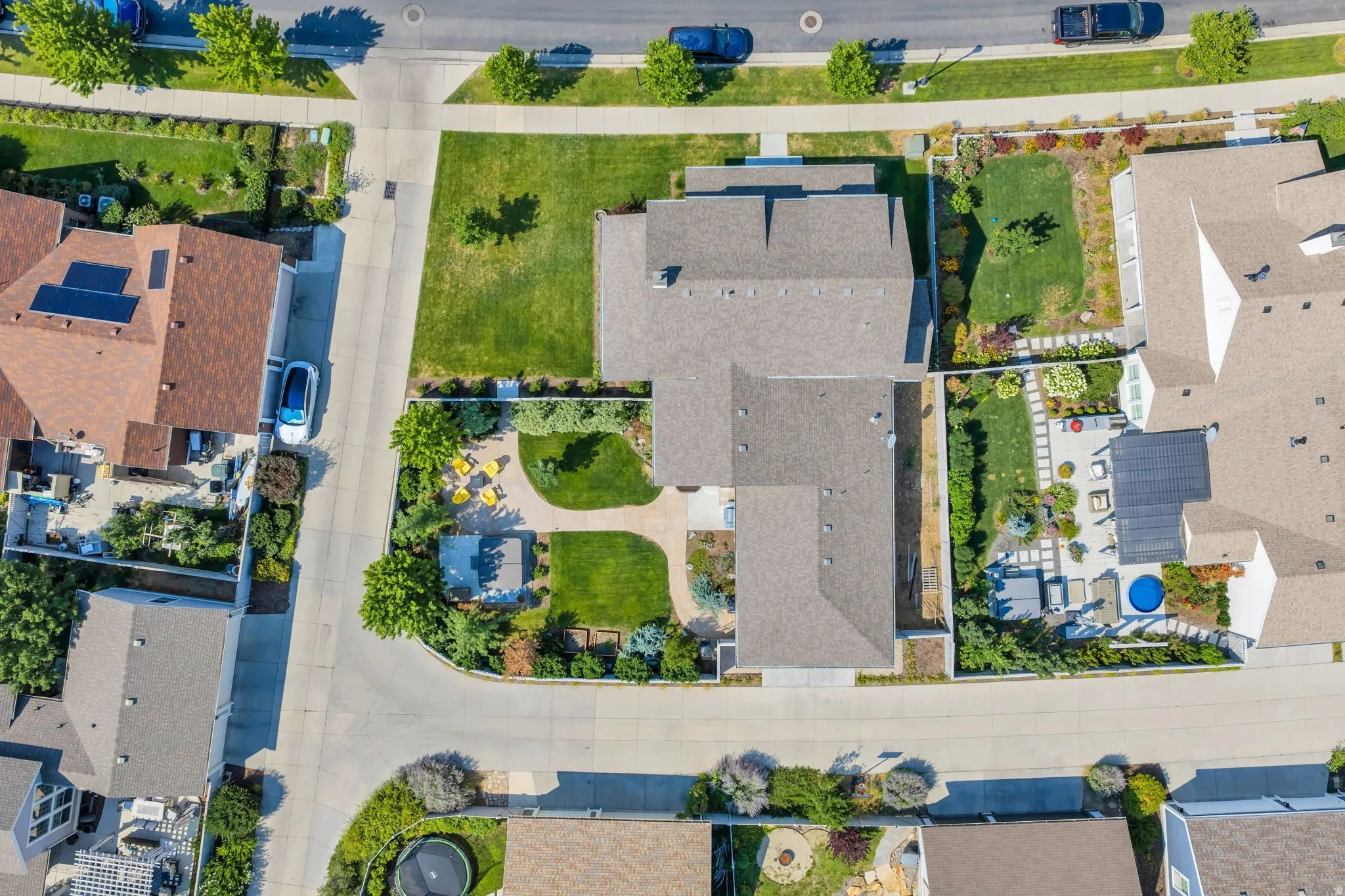 Manicured landscaping with mature trees, expansive green lawns, and a private courtyard