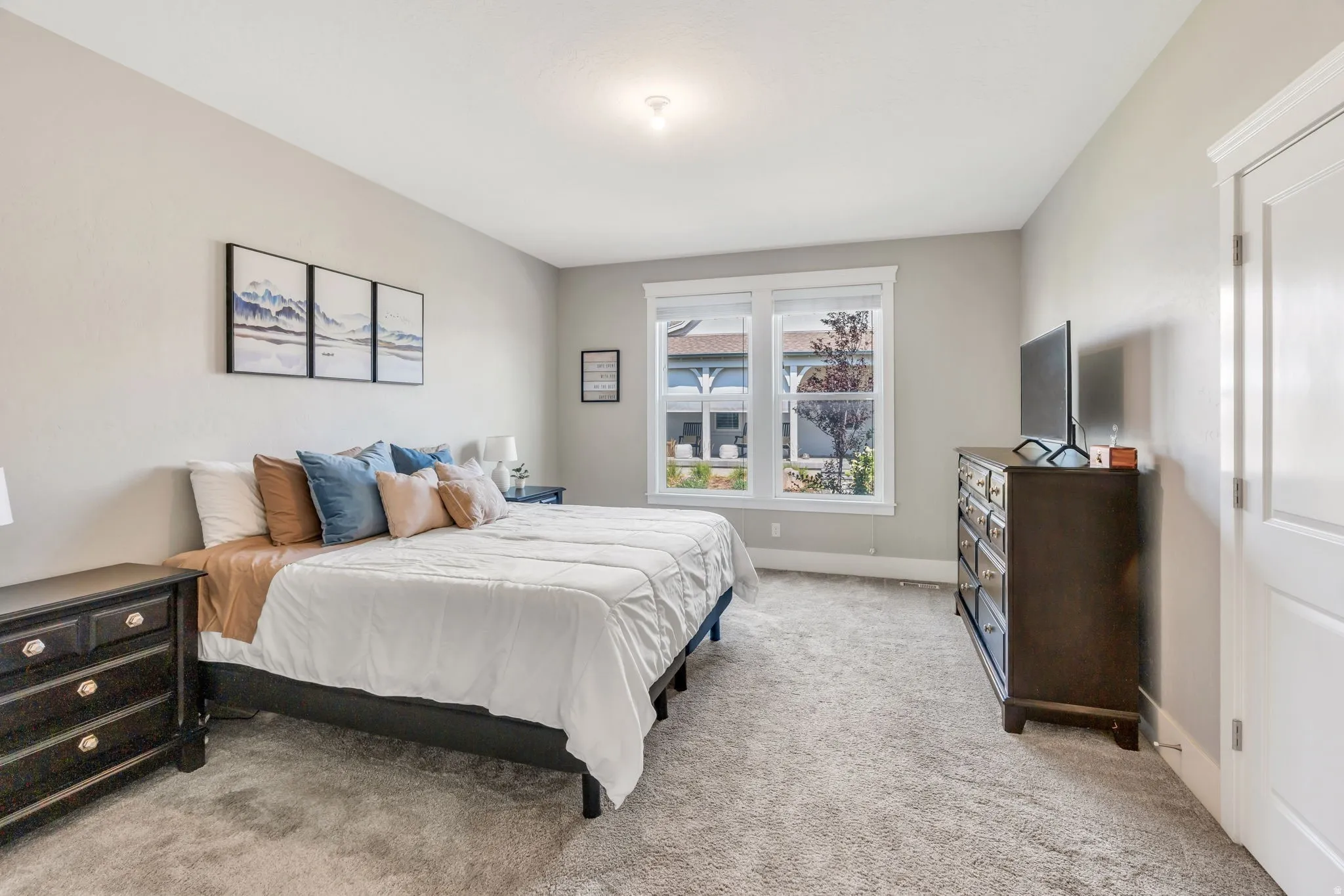 Neutral-toned walls complement the light gray carpeting