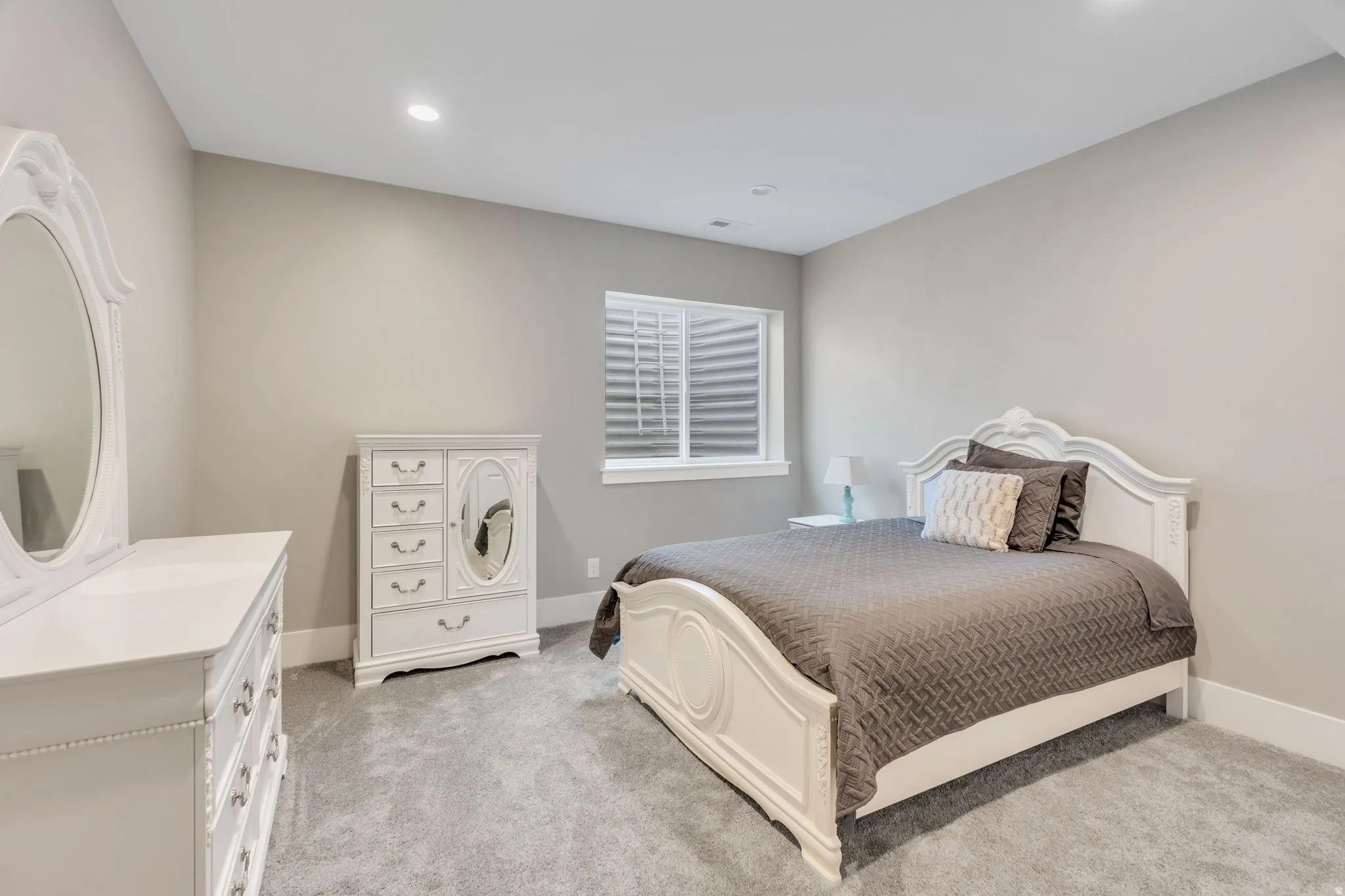 Recessed lighting, light gray wall paint, white trim, and gray carpeting