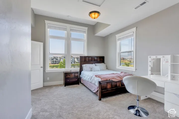 Carpeted flooring, recessed lighting, and a multi-pane window with white trim
