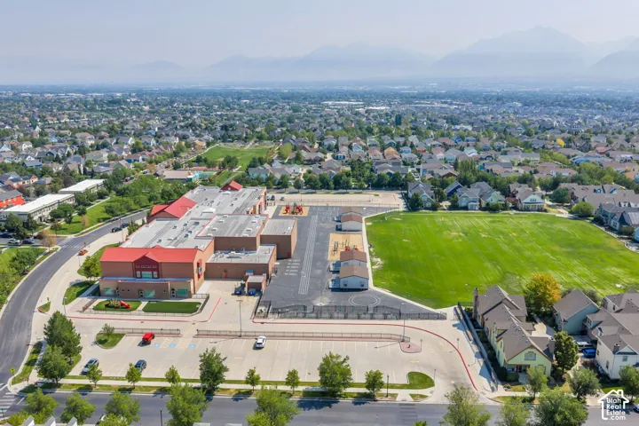 Expansive green space and surrounding residential properties with distant mountain scenery