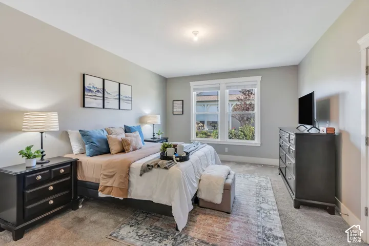Plush carpeting, neutral wall tones, and recessed lighting create a comfortable atmosphere