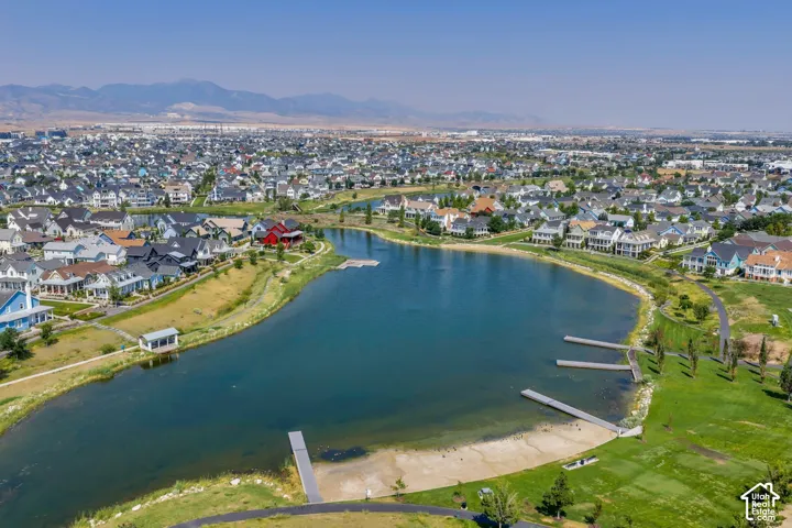 Expansive residential development with a large central lake, multiple docks, and a sandy shore