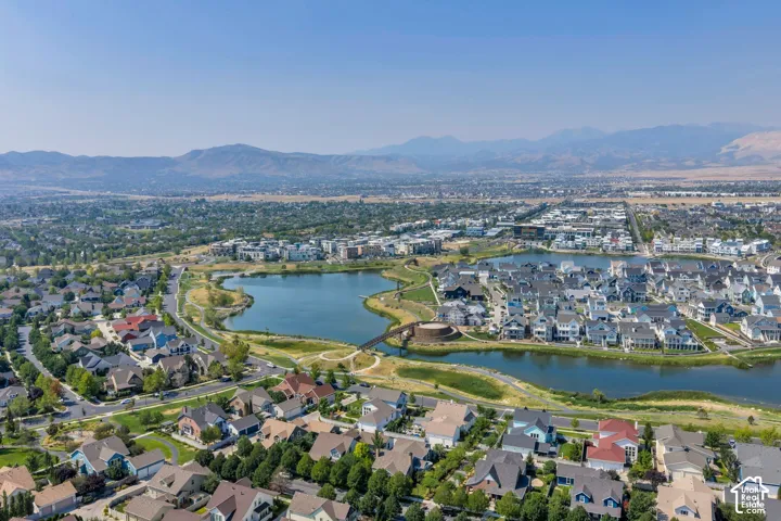 Aerial perspective showcasing a residential community with varied rooflines and a prominent central lake feature