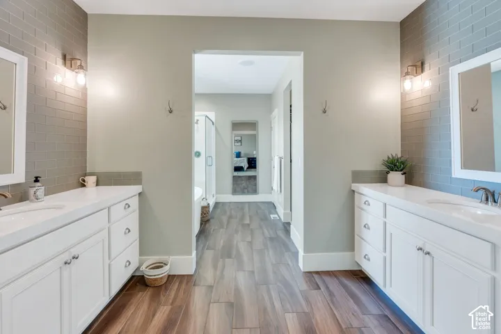 Dual vanities with white cabinetry and integrated sinks