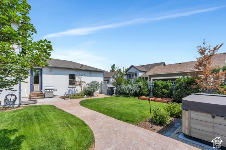 With lush grass and vegetation lining the yard! Includes a hot tub  and planter boxes!