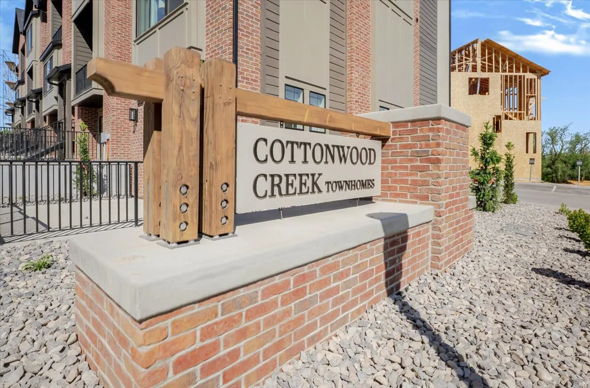 Brick and concrete sign structure with wood-finish accents