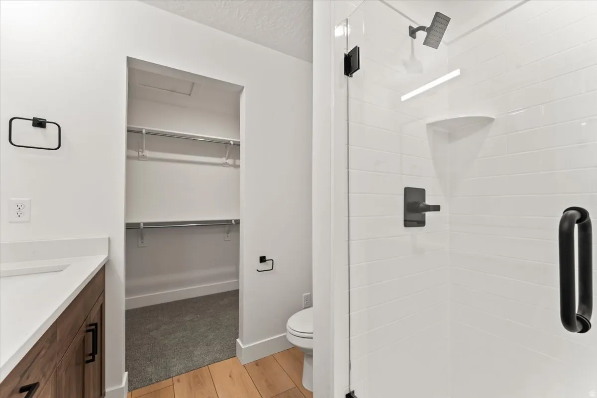 Walk-in shower with clear glass enclosure and black fixtures