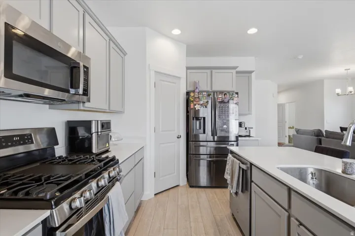 Kitchen featuring light gray cabinetry, light countertops, and LVP wood-finish flooring