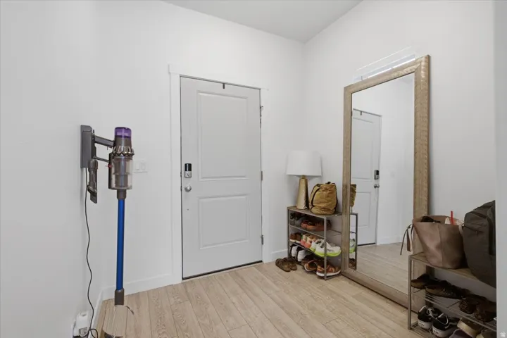 Entryway featuring light wood-finish flooring, and white trim