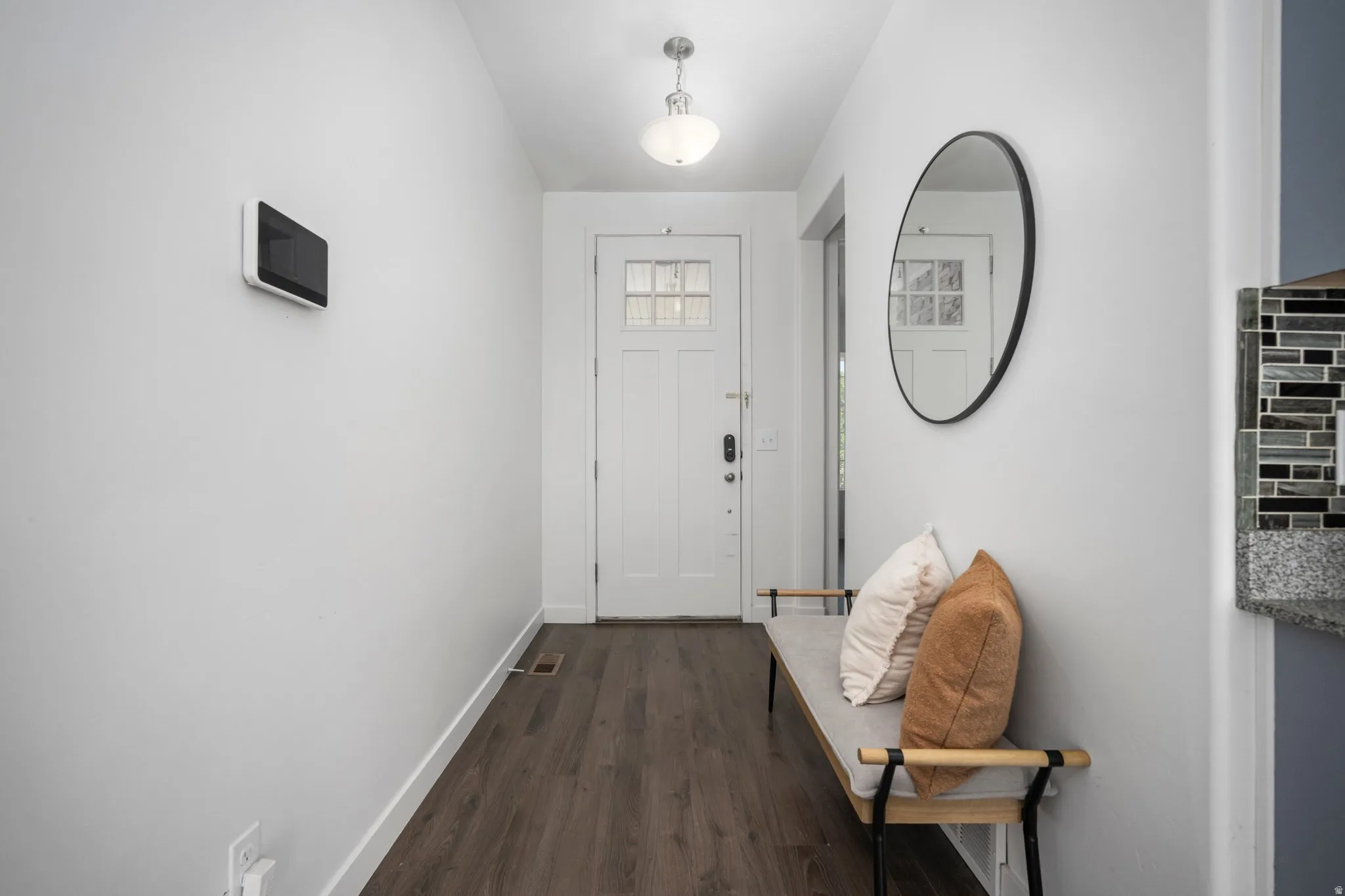 Entryway featuring a white paneled door with glass inserts, wood-finish flooring, and a flush-mount ceiling light
