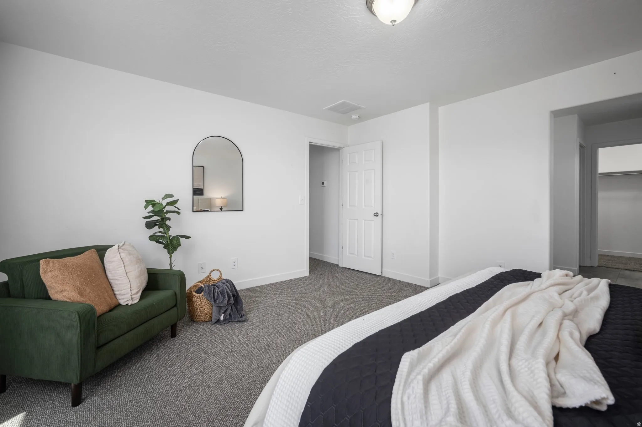 Wall-to-wall carpeting and white walls