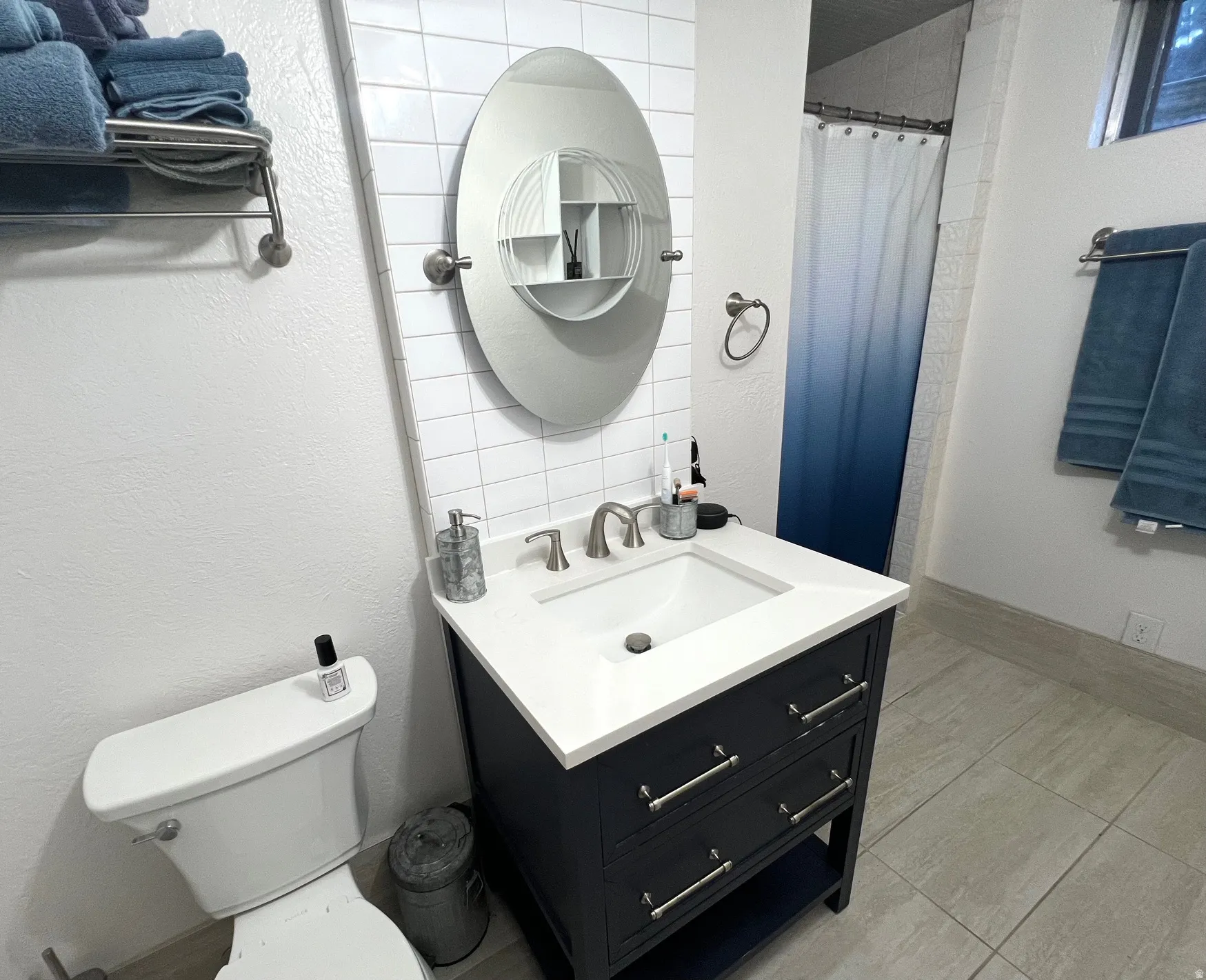Vanity with white countertop, undermount sink, and brushed nickel faucet