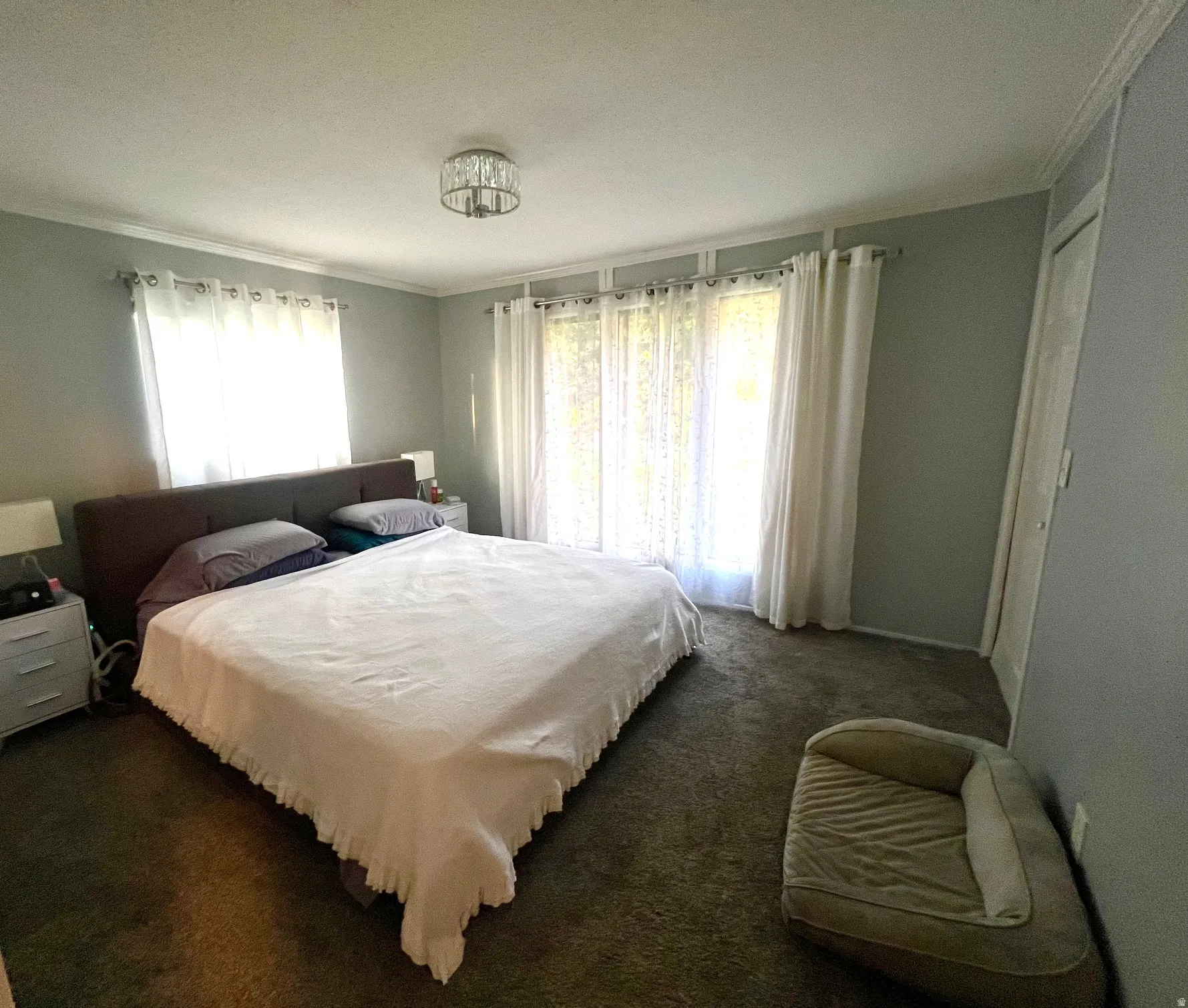 Recessed lighting, crown molding, and neutral wall tones complement the room's design