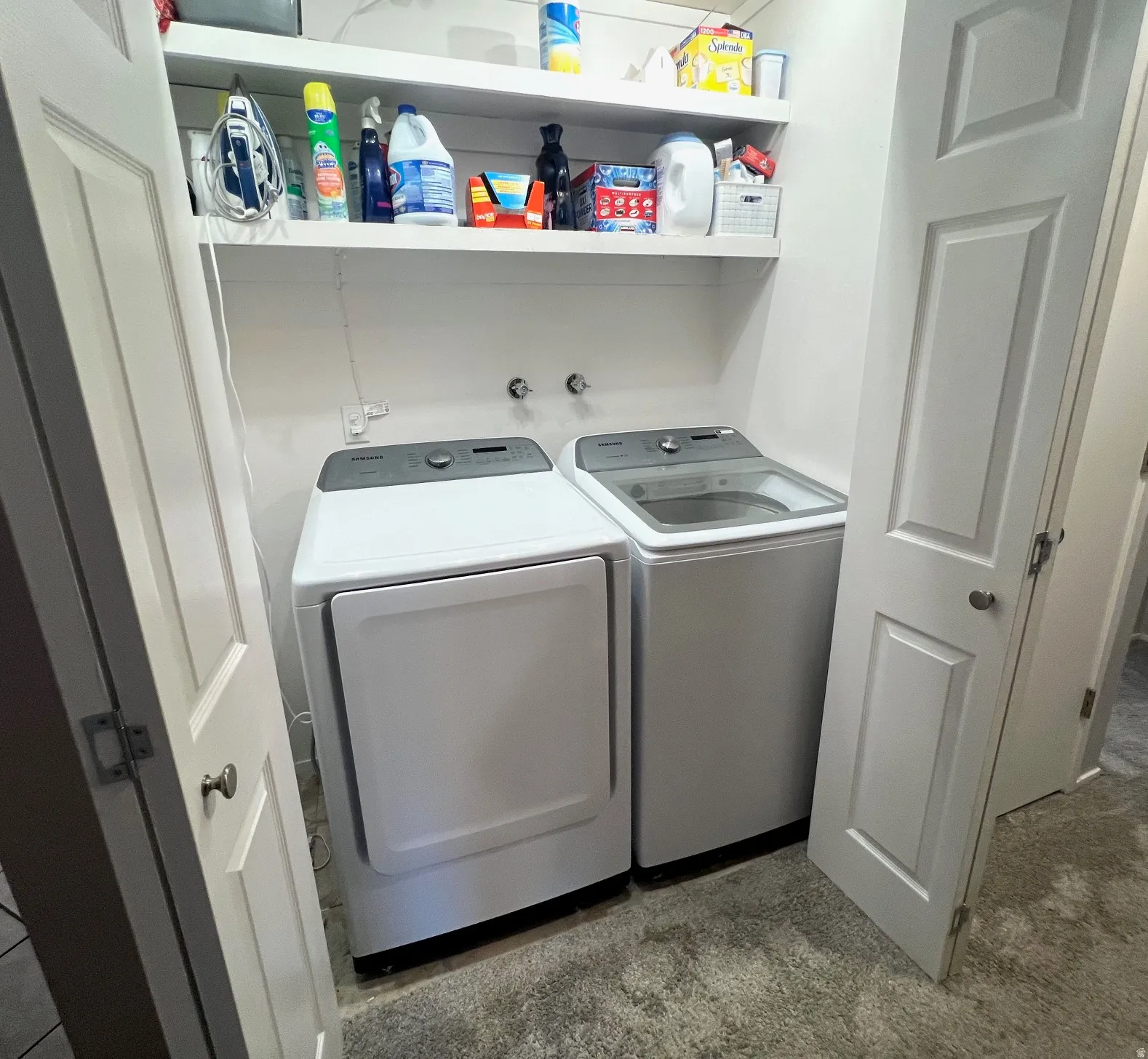 Built-in shelving, white paneled doors, and a textured floor finish