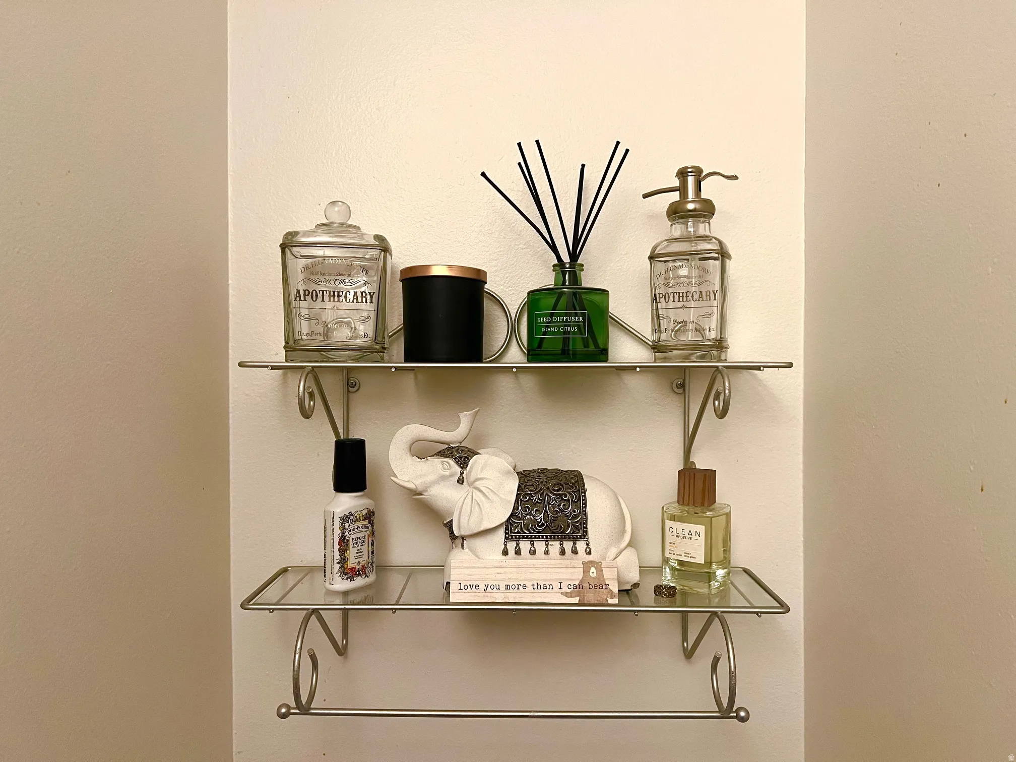 Wall-mounted metal shelving with a lower towel bar