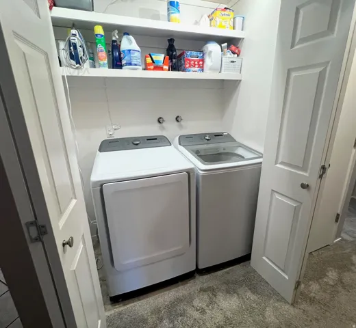 Built-in shelving, white paneled doors, and a textured floor finish
