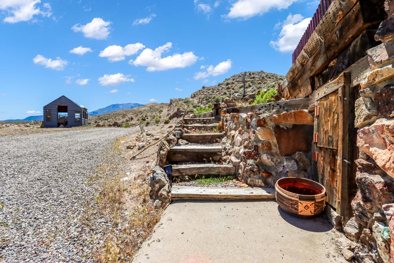 Stone and timber-faced structure with a rustic wooden door and built-in wooden steps