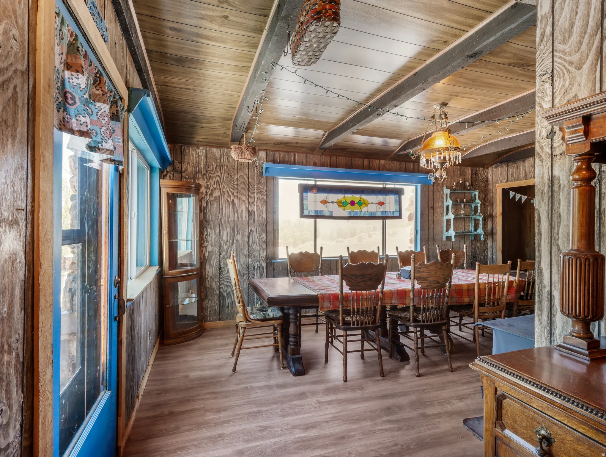 Wood-finish flooring, wood plank walls, and exposed ceiling beams