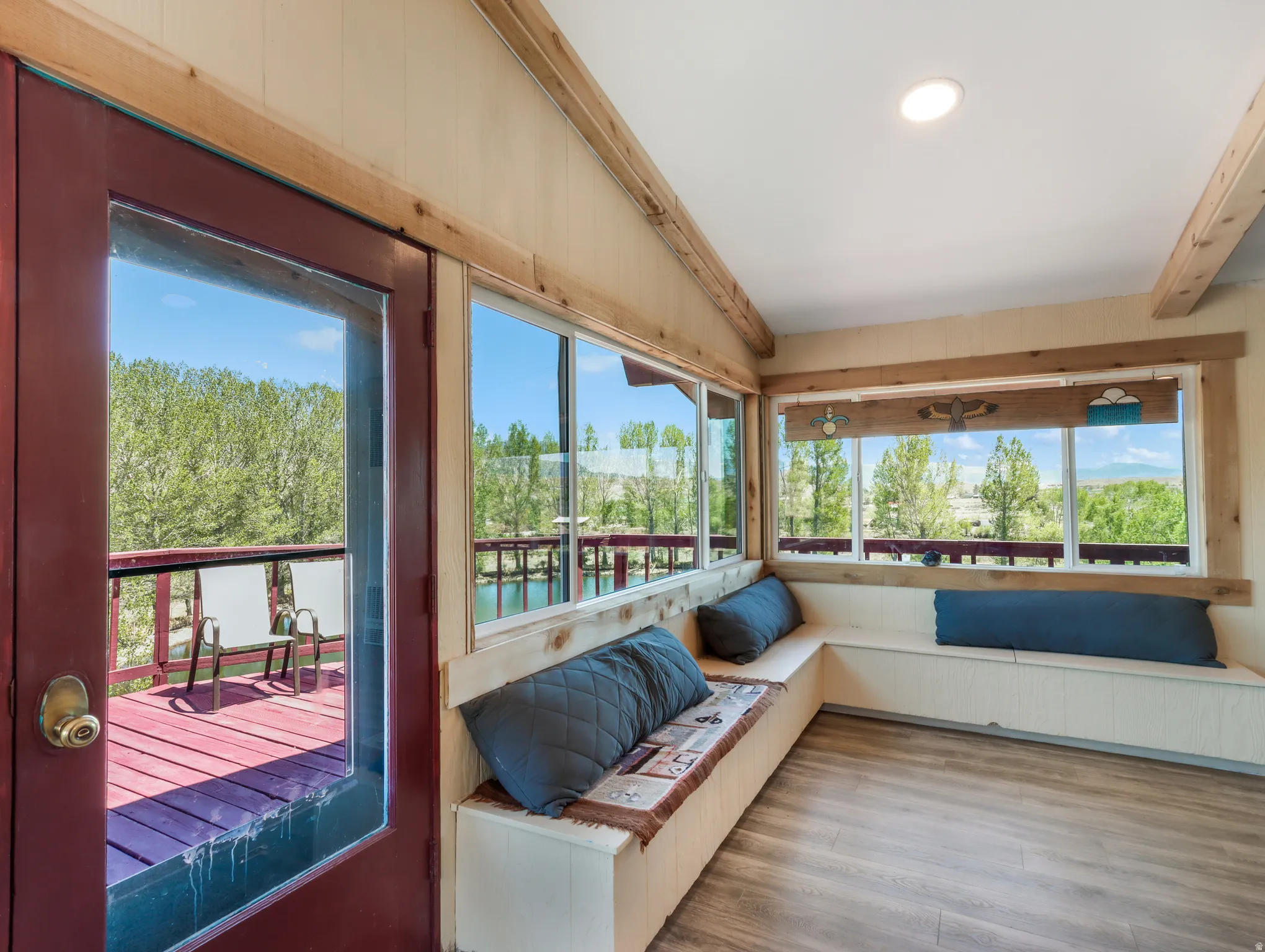 Wood-finish flooring, built-in bench seating, recessed lighting, and expansive windows
