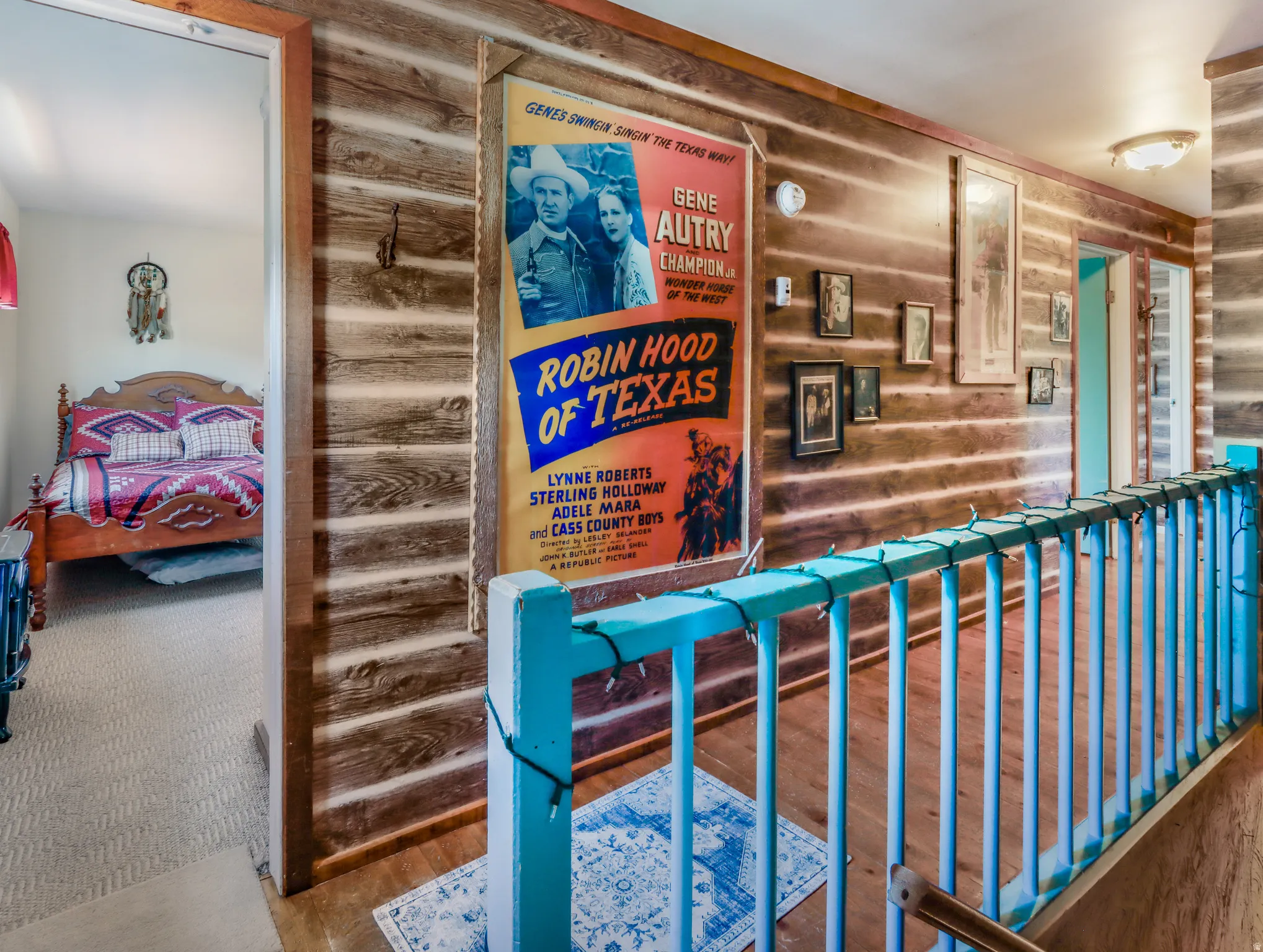 Wood-paneled hallway featuring wood-finish flooring and a painted railing
