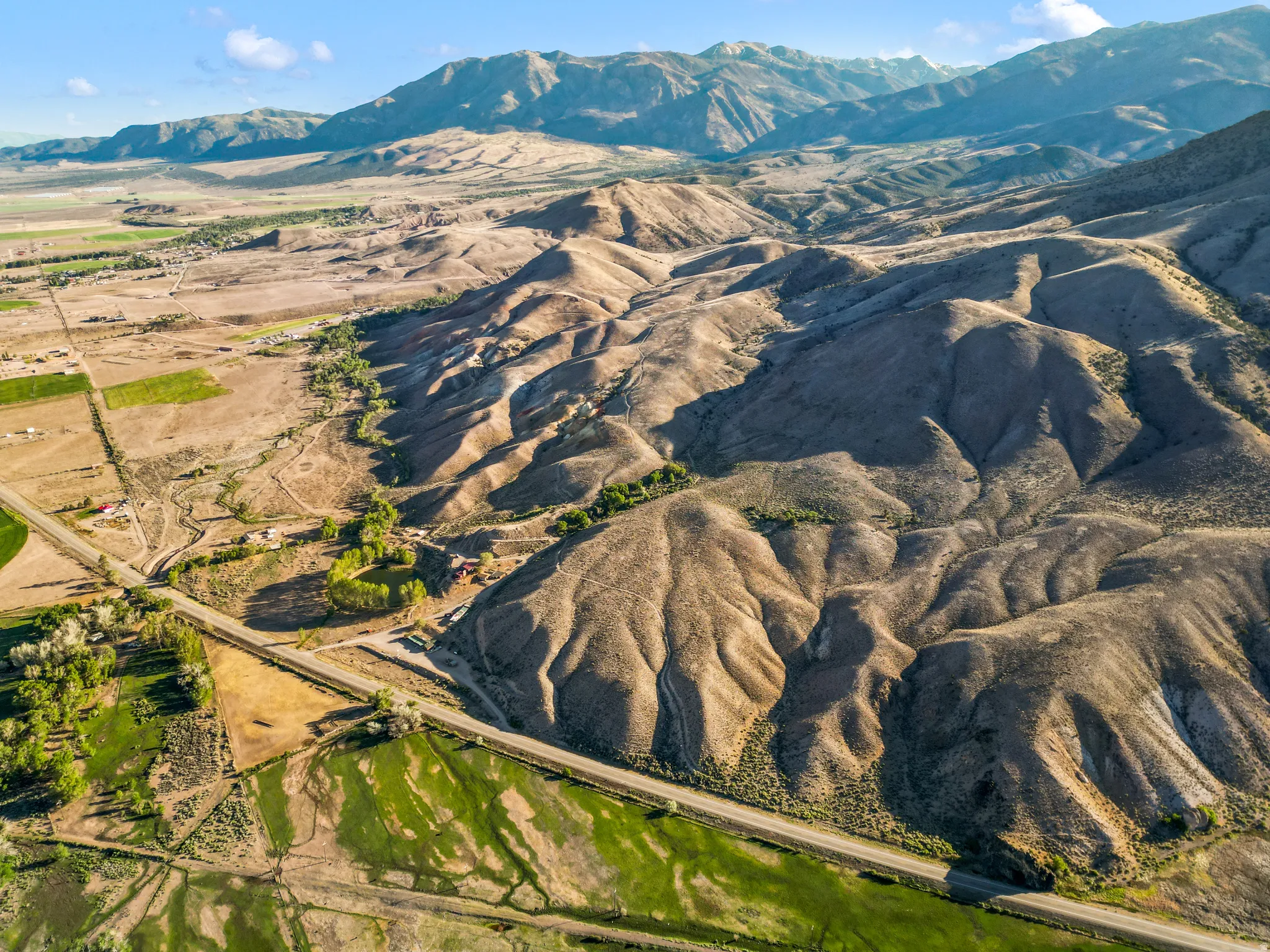 Expansive land parcel featuring diverse topography, including rolling hills and flat plains