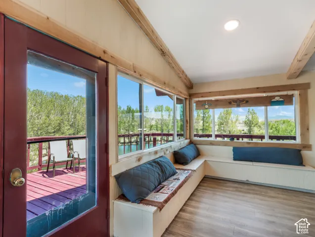 Wood-finish flooring, built-in bench seating, recessed lighting, and expansive windows
