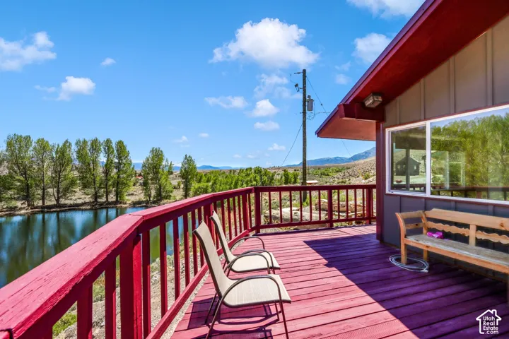 Expansive outdoor deck with a red railing and matching wood-finish flooring