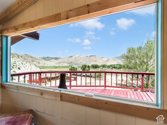 Expansive window providing broad outdoor scenery, wood-paneled walls, and wood trim details